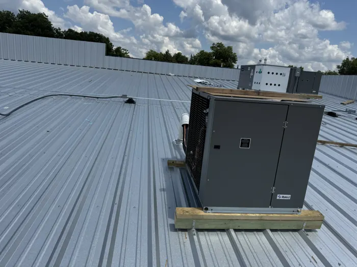 Commercial refrigeration condensing unit on a metal roof