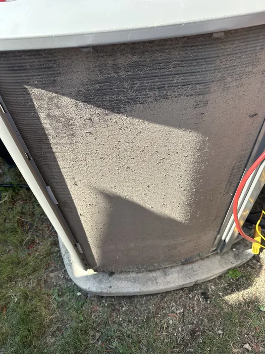 Close-up of dirt and lint on an outdoor AC coil
