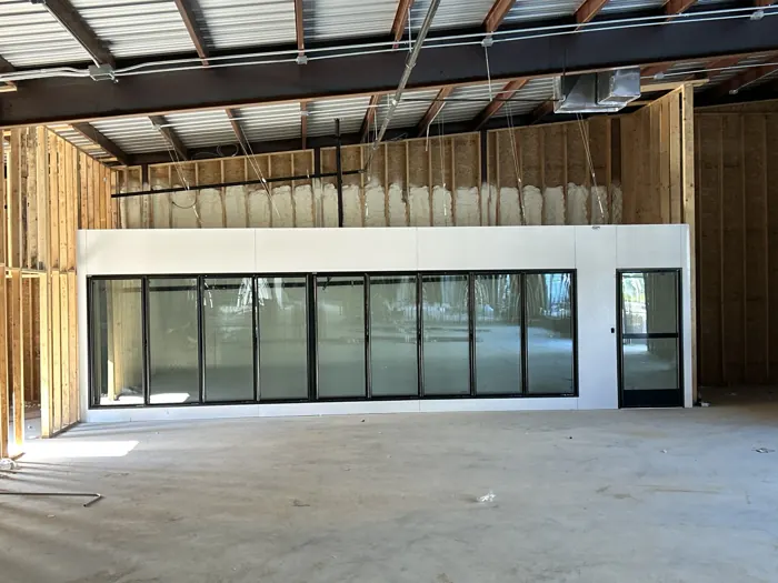 Glass-door cooler wall for a retail store