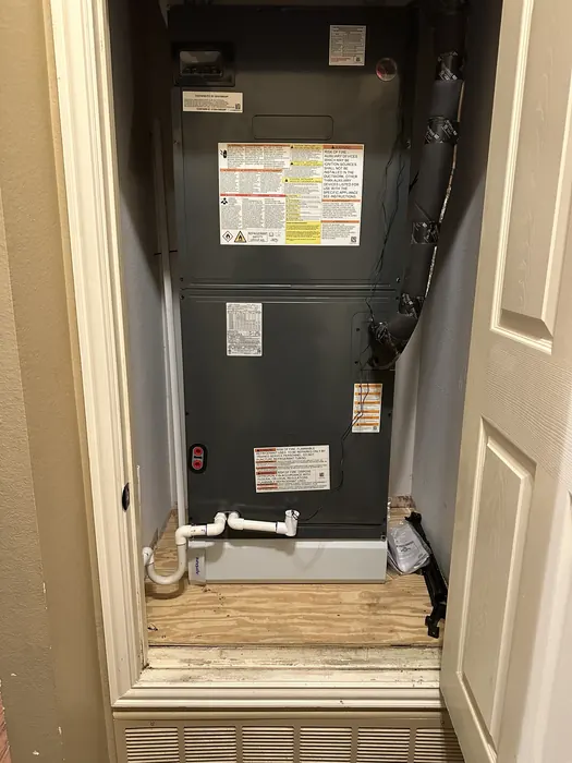 Newly installed air handler in a hall closet with new drain line