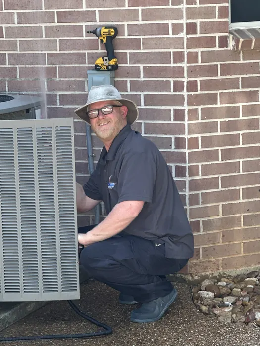 Streamline HVAC technician servicing an outdoor AC unit