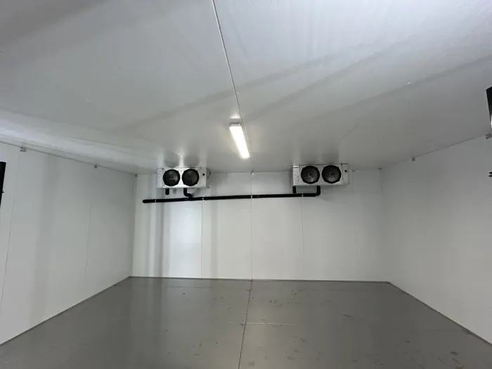 Walk-in cooler interior with evaporator coils