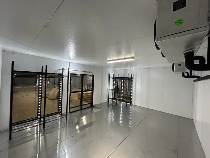 Walk-in cooler with glass merchandising doors