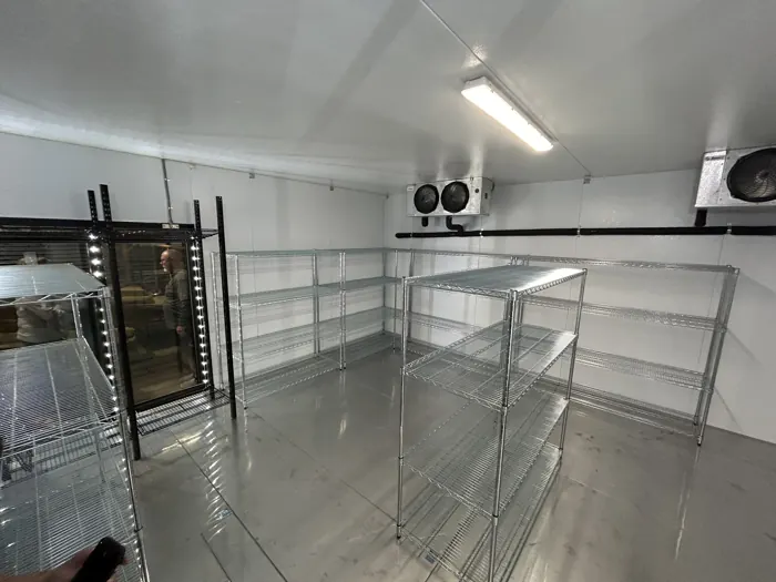 Finished walk-in cooler with shelving and glass doors