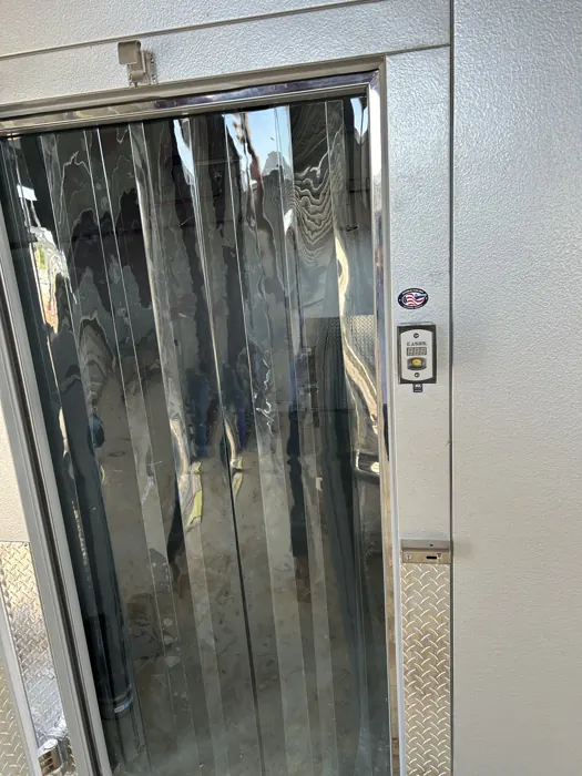 Walk-in cooler door with strip curtain