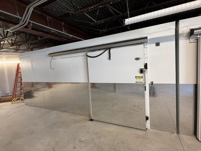 Commercial walk-in freezer sliding door installation
